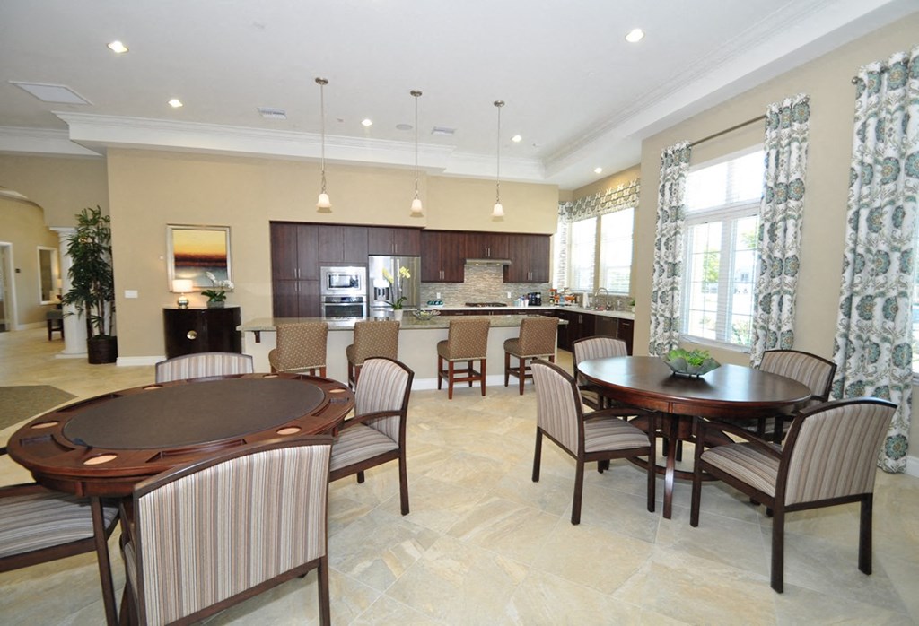 A large dining room with a round table and chairs.