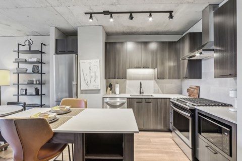 A modern kitchen with a dining table and chairs.