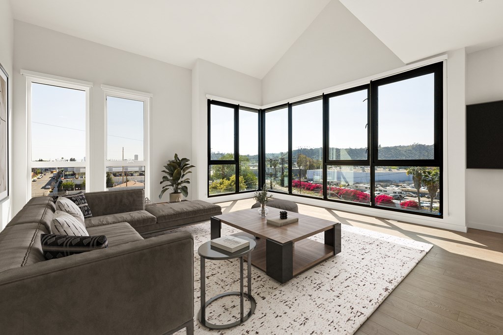 A living room with a brown couch and a coffee table.