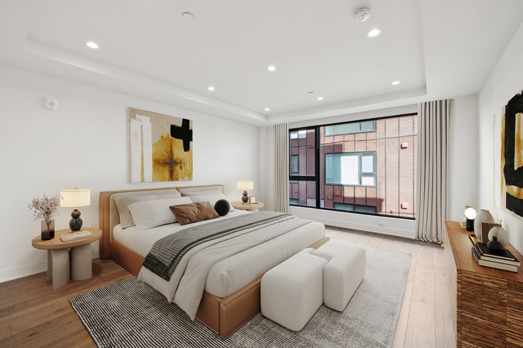 A bedroom with a large bed and a window.