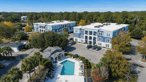 A large building with a pool in front of it.