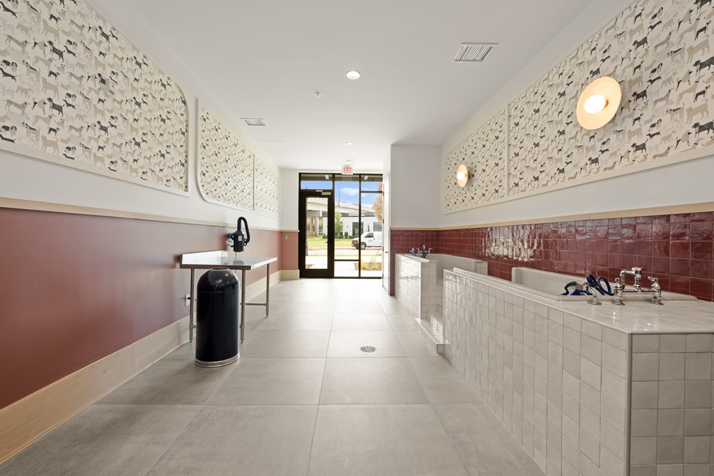 A bathroom with a red wall and a white tiled sink.