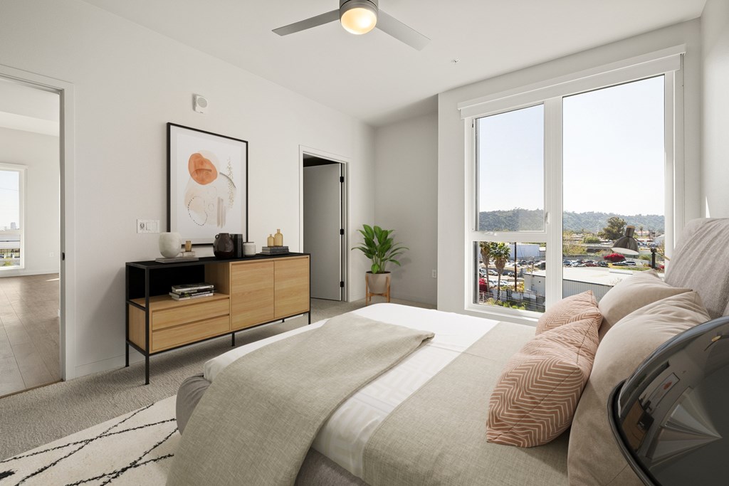 A bedroom with a large bed and a view of the city.