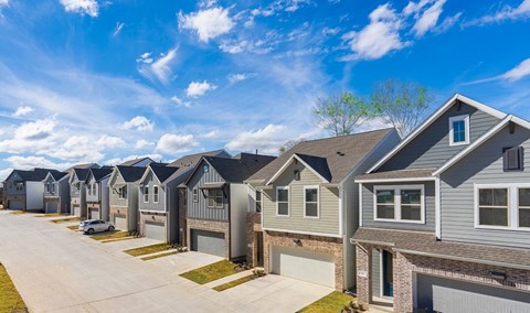 a row of houses in front of a blue sky