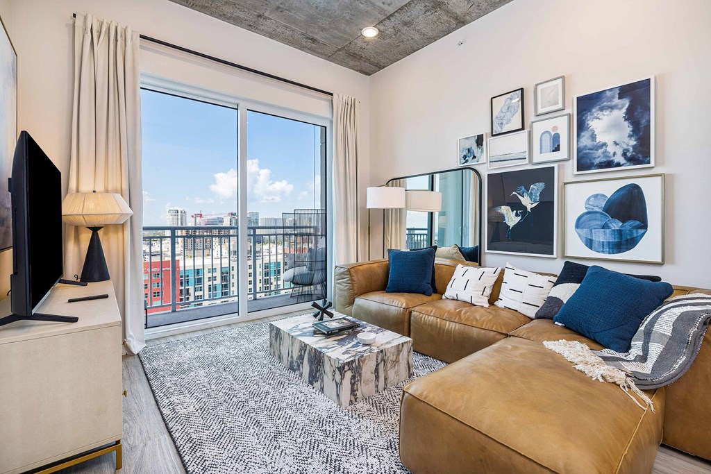 a living room with a leather couch and a tv
