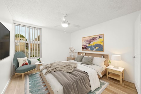 a bedroom with a large bed and a tv
