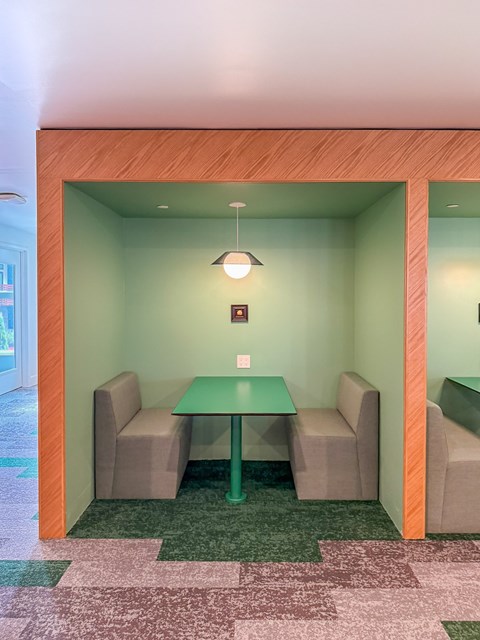 A small room with a table and four chairs.