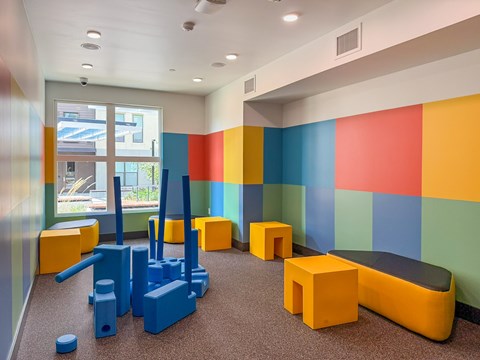 A gym with a blue weight bench and a blue weight set.