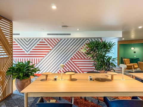 A conference room with a wooden table and chairs.