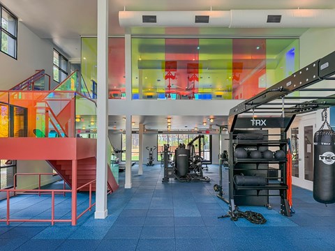 A gym with a punching bag and exercise equipment.