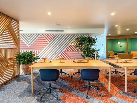 A modern office with a wooden table and chairs.