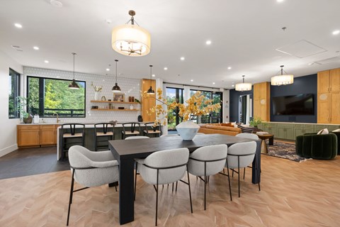 A modern dining room with a large table and chairs.