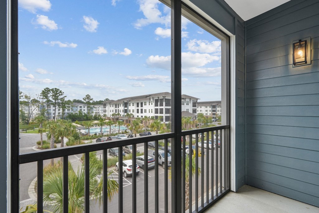 a balcony with a view of a building and palm trees