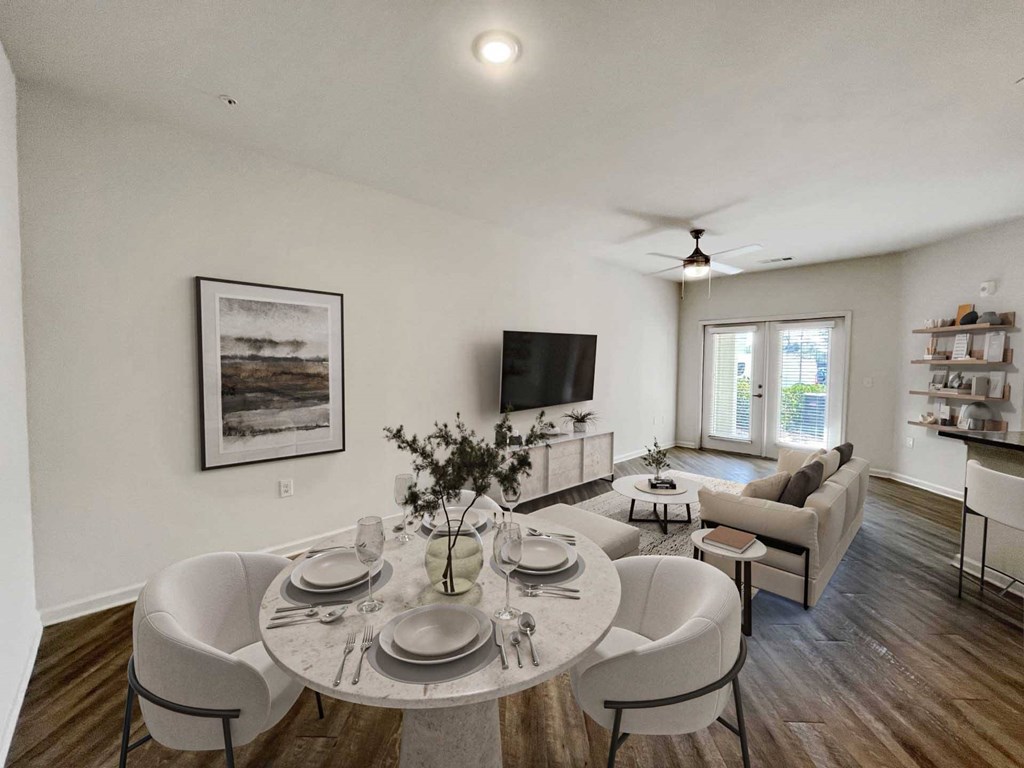 A dining room with a round table set for six.
