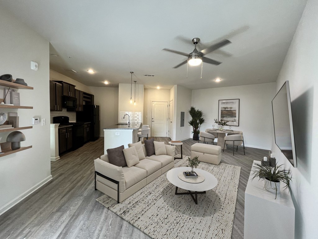 A modern living room with a grey sofa set and a white coffee table.