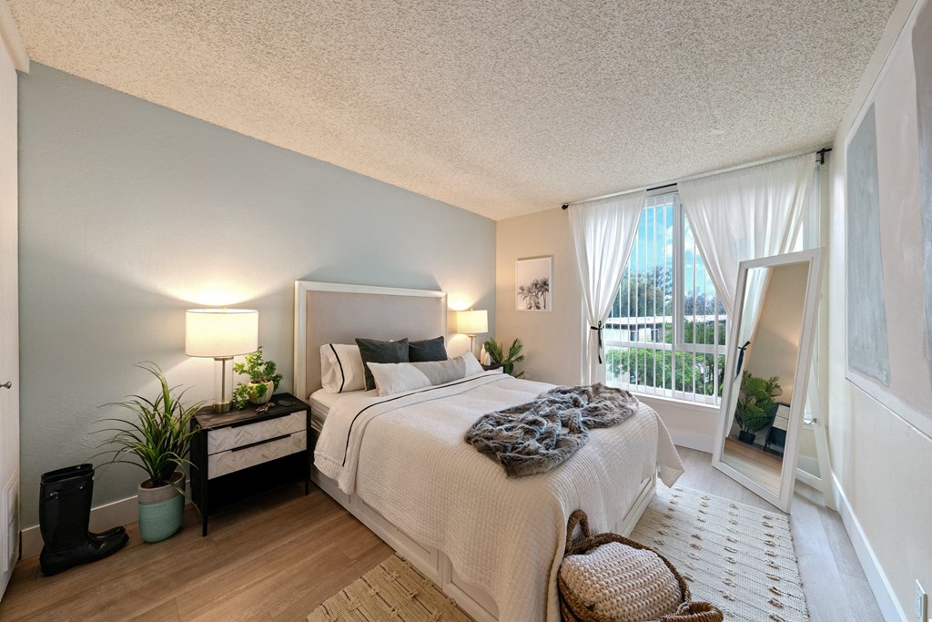 a bedroom with a large bed and a large window