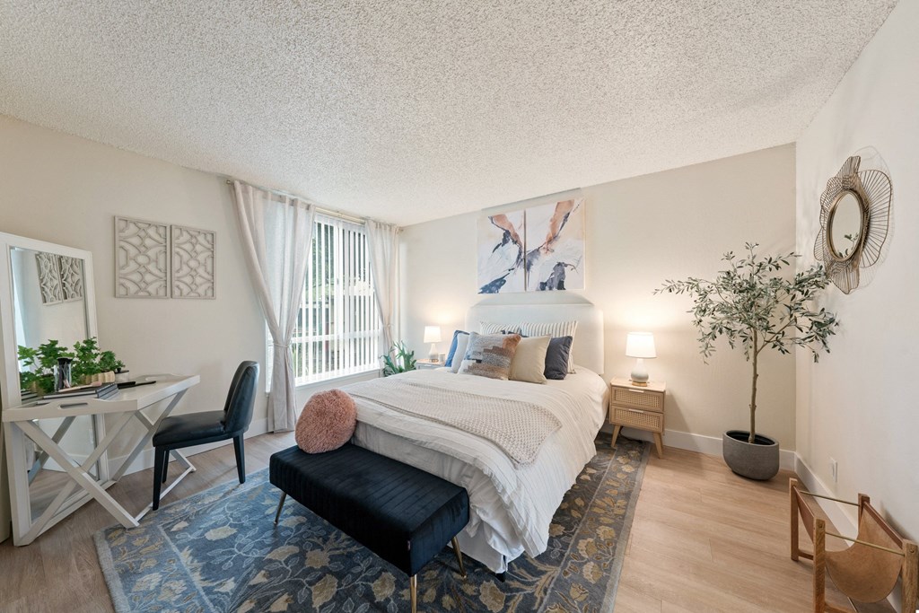 a bedroom with a bed and a desk in a 555 waverly unit
