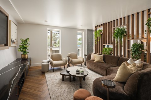 A living room with a brown couch and a coffee table.