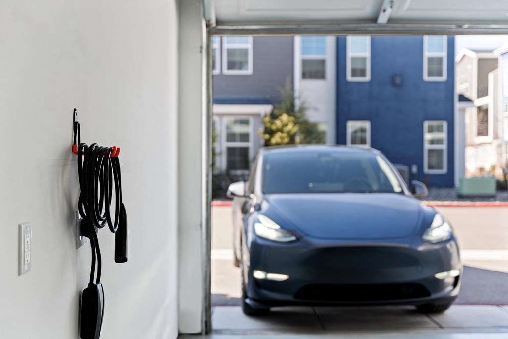 a tesla model 3 electric car is parked at a charging station in san francisco