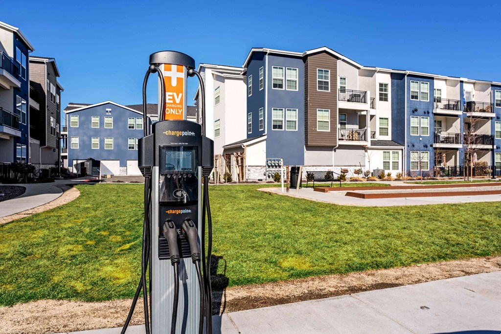 a gas station with an apartment building in the background