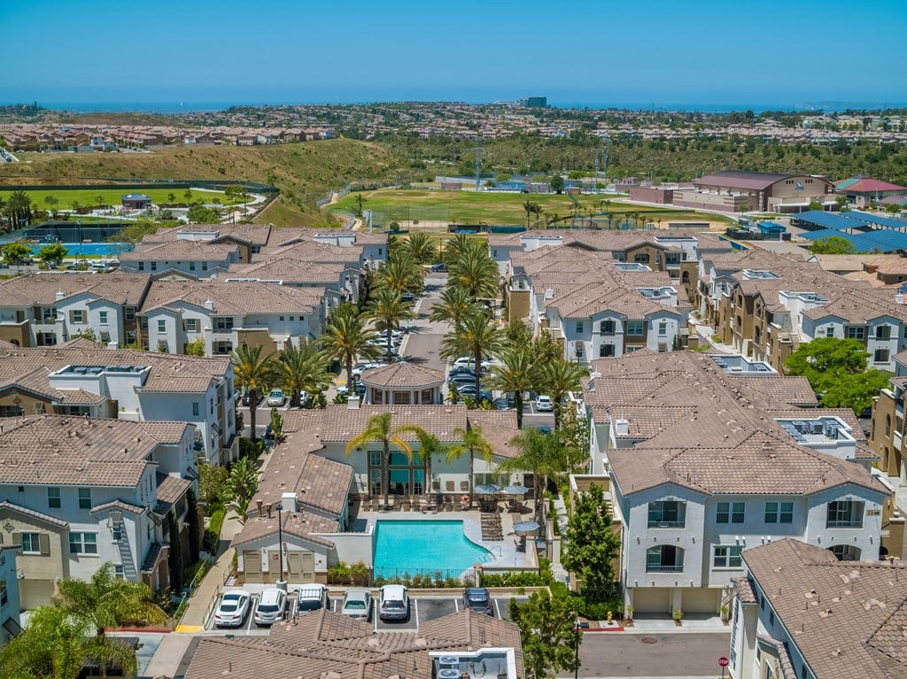 A view of a residential area with houses and a pool.