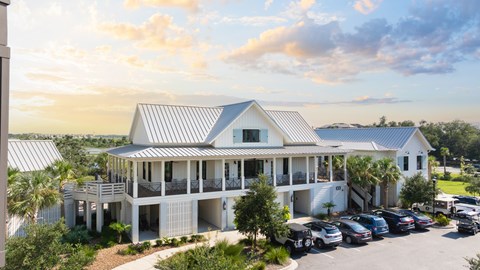 A white house with a metal roof and a carport.