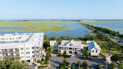 A large white building with a parking lot in front of it.