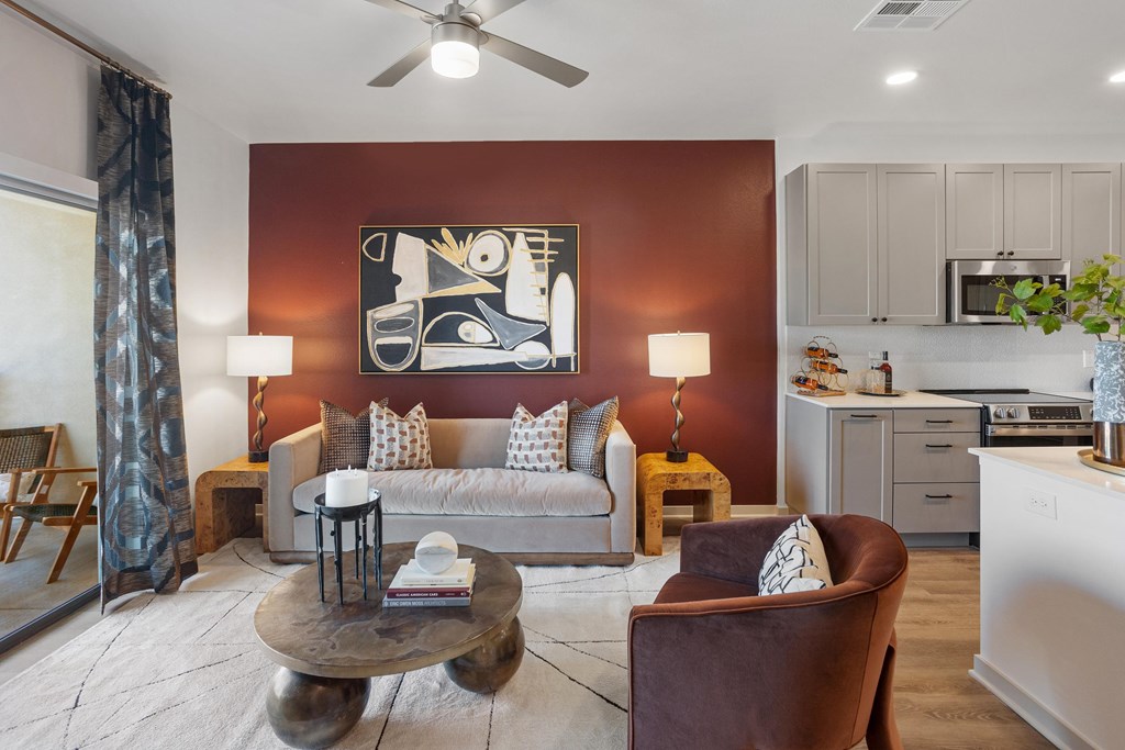 A living room with a brown chair and a white couch.