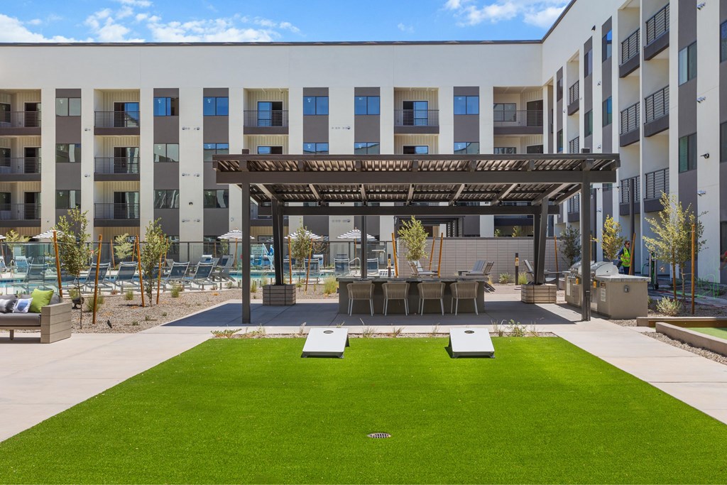 A modern building with a green lawn in front.