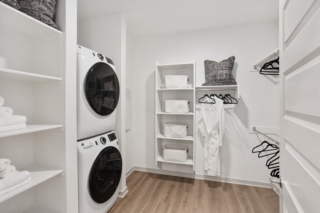 A laundry room with a washer and dryer stacked on top of each other.