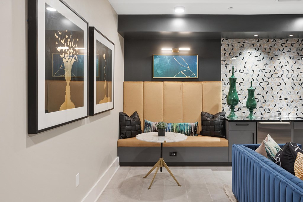 A living room with a blue couch and a brown sofa.