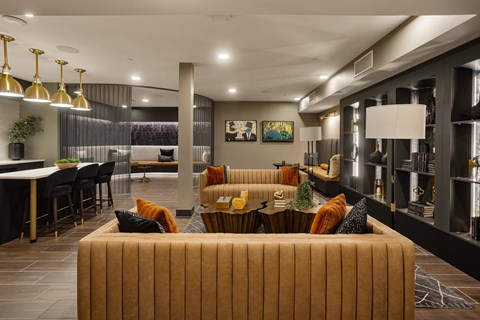 A modern living room with a large sofa and a dining table.