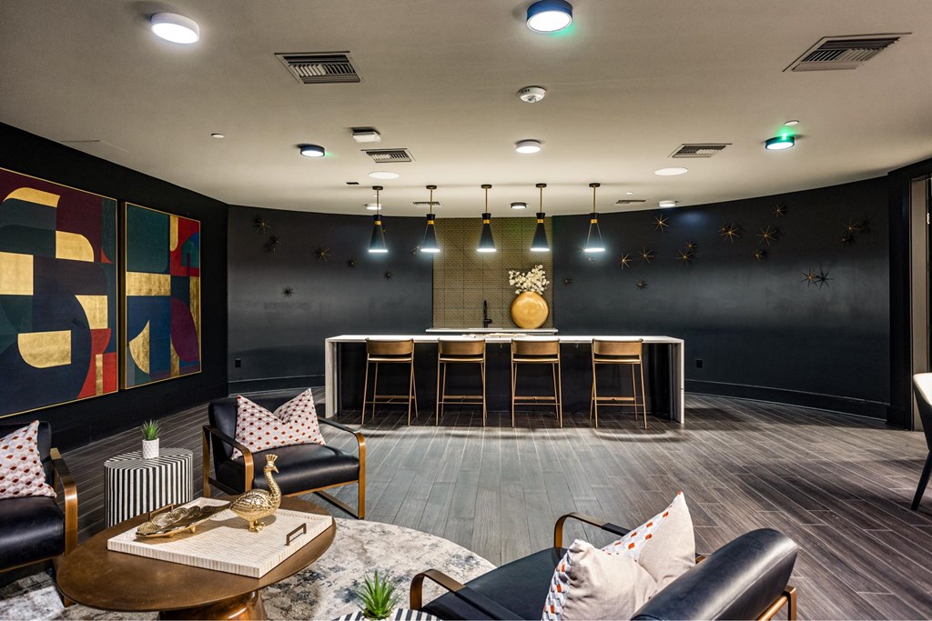 A modern living room with a bar and comfortable seating.