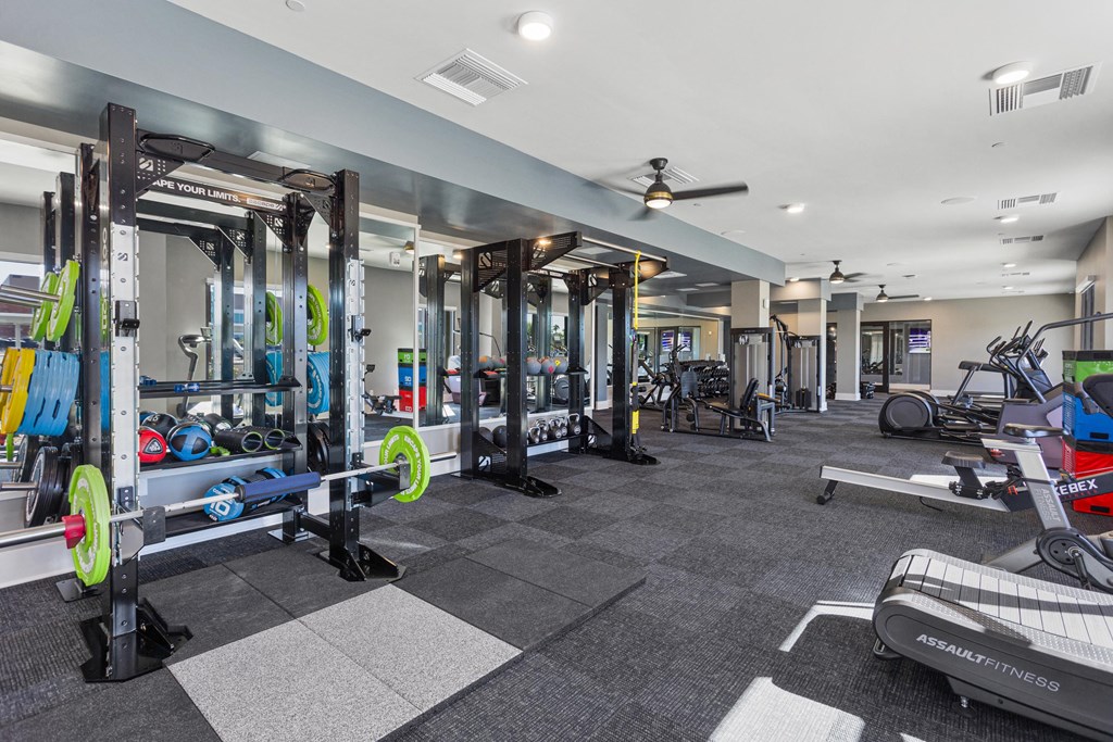 a gym with weights and other exercise equipment in a building with