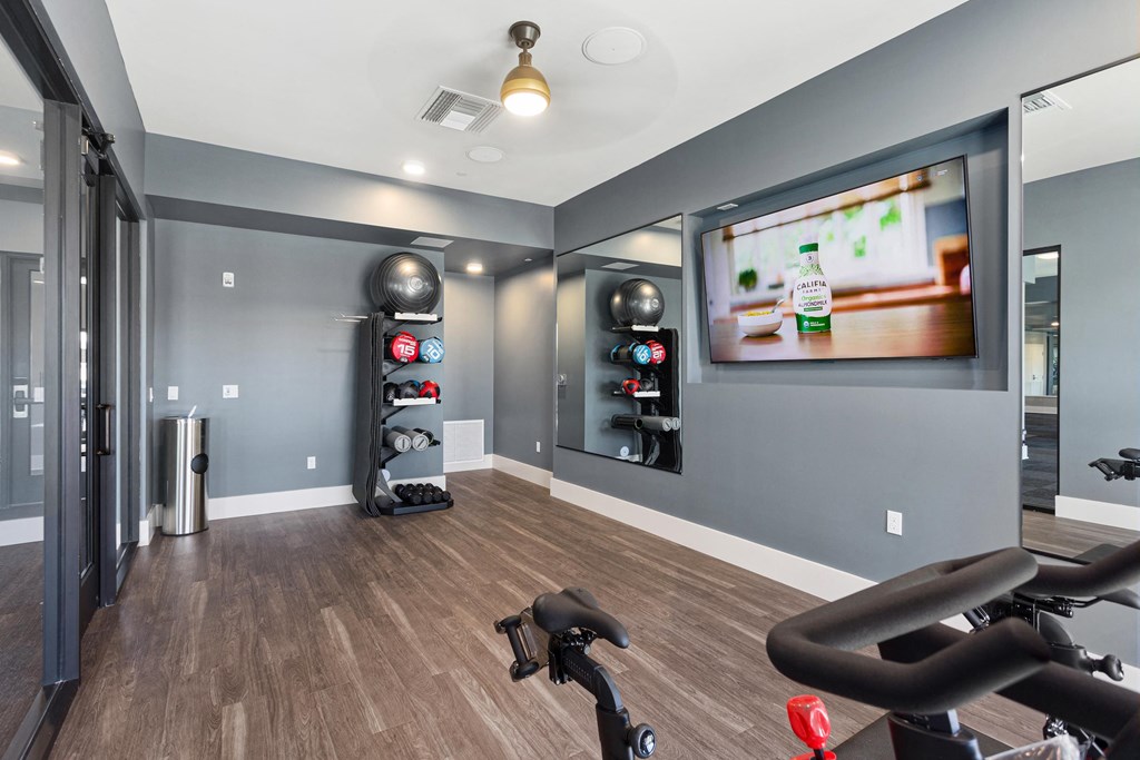 the gym at the district flats apartments in lenexa