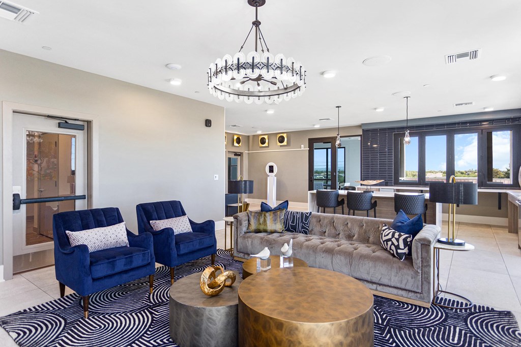 a living room with couches and chairs and a chandelier