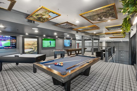 A room with a pool table and a snooker table.