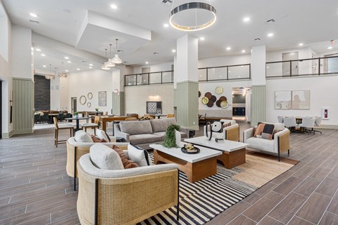 A spacious living room with a mix of modern and traditional furniture.