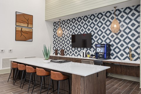 A kitchen with a white counter top and brown bar stools.