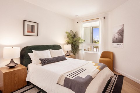 a bedroom with a large bed and a window