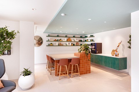 a dining room with a table and chairs and a kitchen