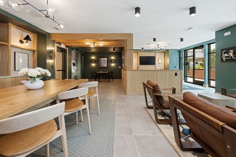 A modern dining room with a long table and chairs.