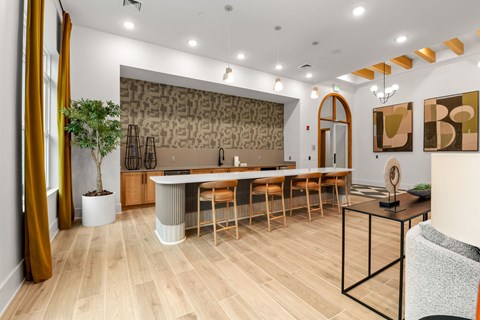 A modern dining room with a long table and chairs.