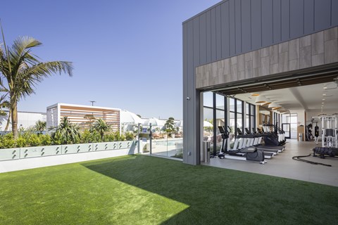 A gym with a green lawn in front of it.
