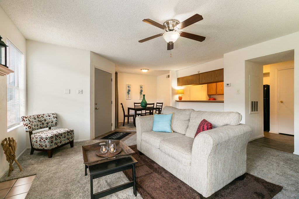 A living room with a couch, chair, and coffee table.