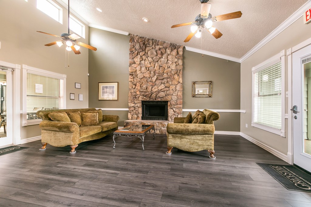 A living room with a stone fireplace and a couch.