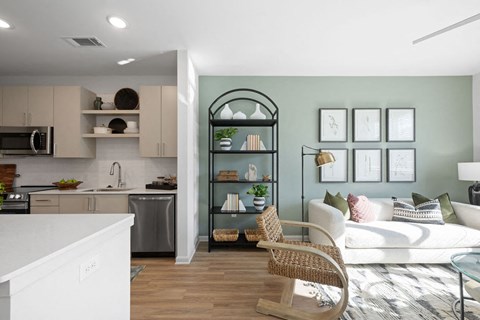 A modern kitchen with a white countertop and a wooden chair.