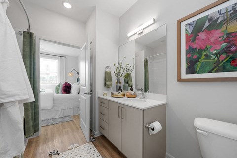 A bathroom with a white tub, sink, and a mirror.