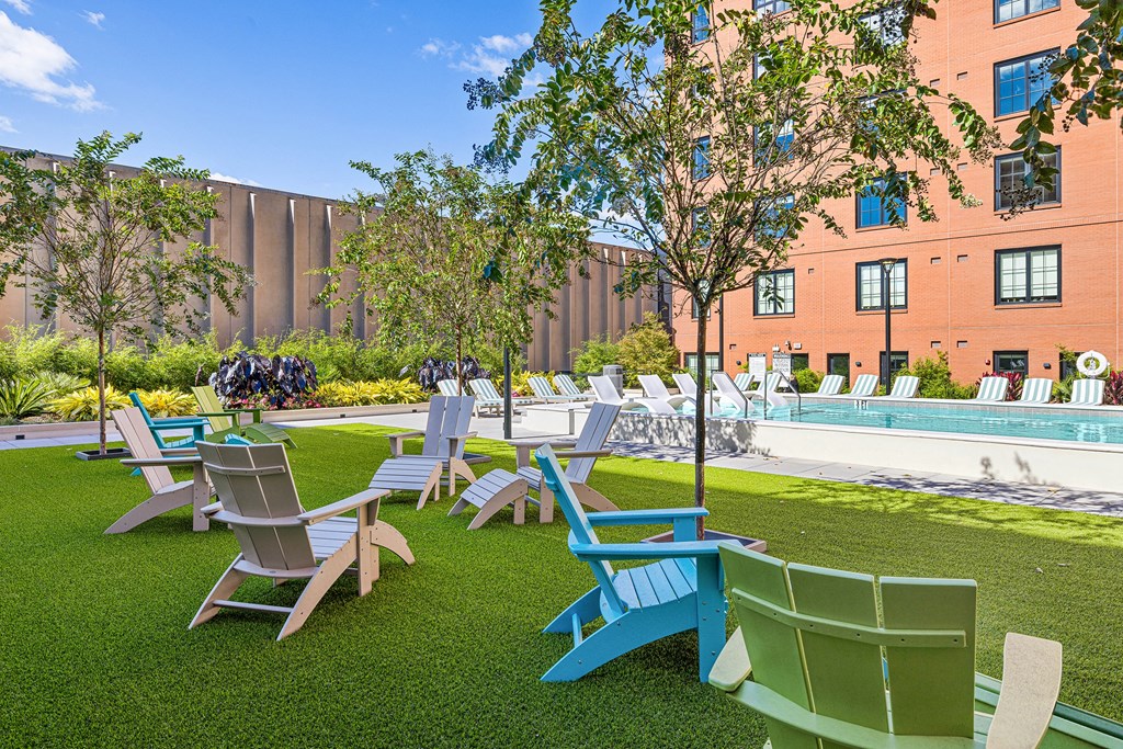 a group of lawn chairs sitting next to a pool