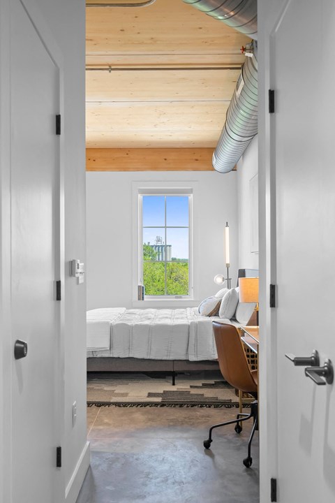 a bedroom with a bed and desk